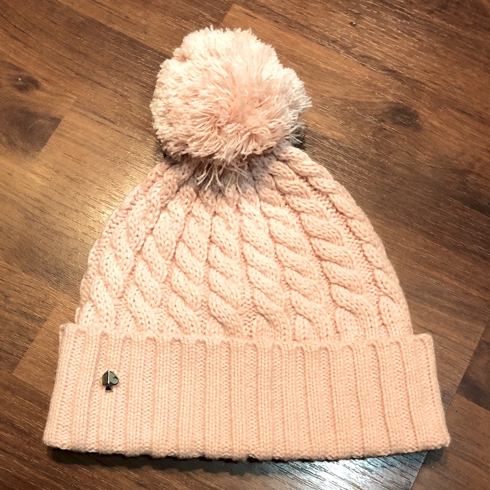 Kate Spade Light Pink Beanie with PomPom. Great condition. Silver spade in front